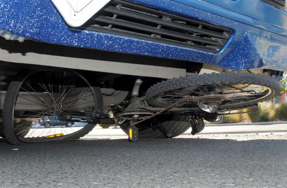 A cycle lies wedged under a  truck in Strathallan St, Dunedin, yesterday after the rider was...