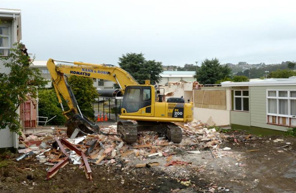 A digger at Dunedin's Bayfield High School, where the archway and front entrance have been...