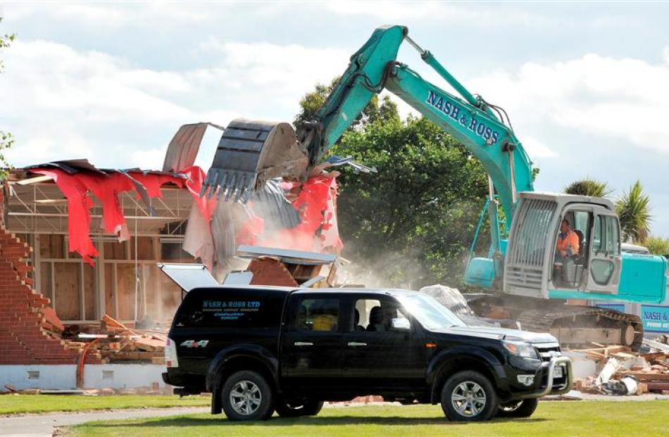 A digger demolishes buildings at the former Waldronville School to make way for a new residential...