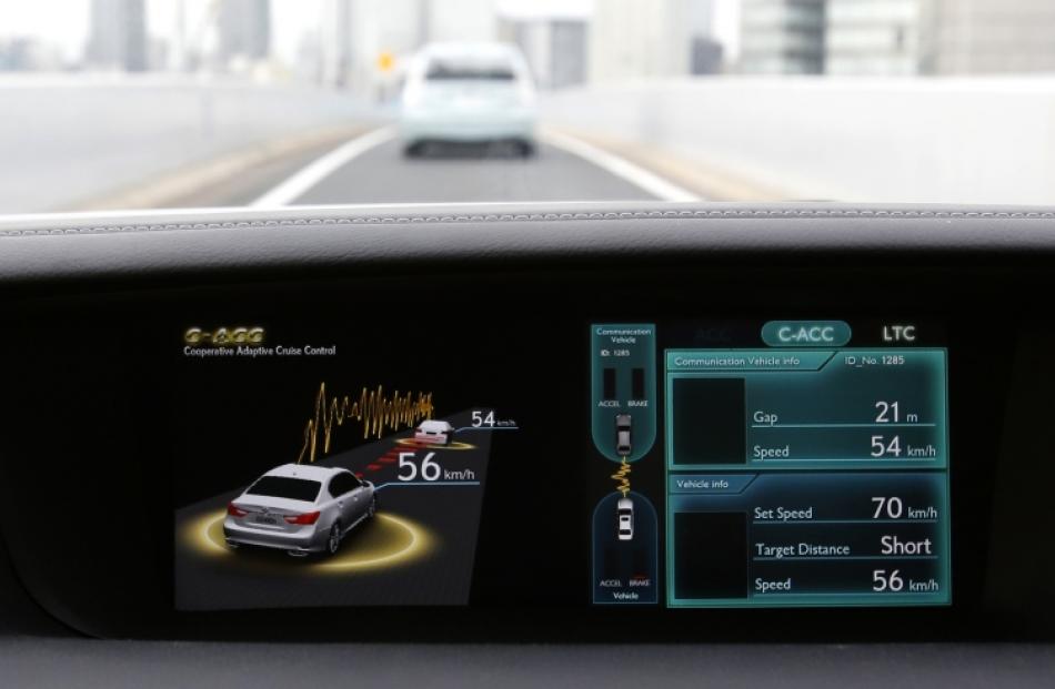 A display on a Toyota test car shows the Co-operative-adaptive Cruise Control, which uses 700-Mhz...