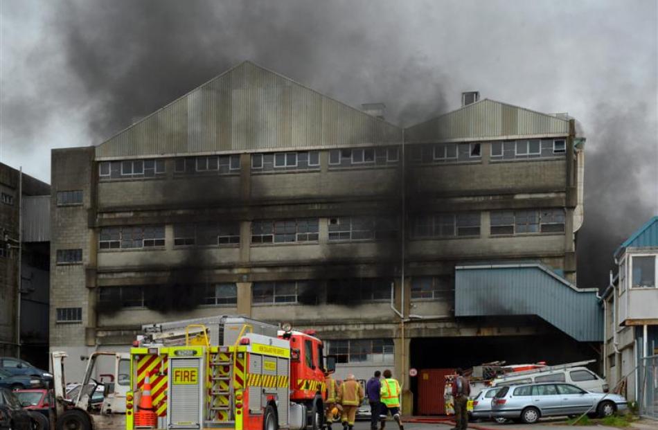 A fire appliance and firefighters at a blaze in the former Burnside freezing works, Kaikorai...
