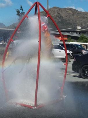 A firefighter is decontaminated after working in the Frankton laundry where chlorine gas was...