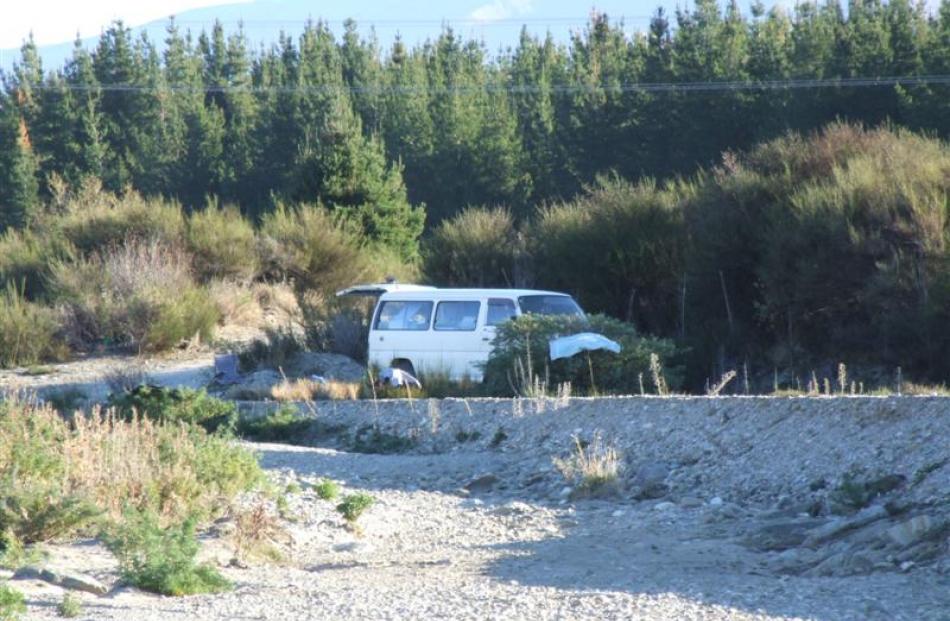 A freedom camper seen parked at a secluded site near the Ballantyne Rd bridge across the Cardrona...
