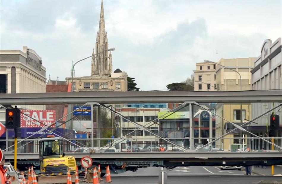 A glass air bridge is transported across Great King St yesterday on its way to Albion Lane, where...