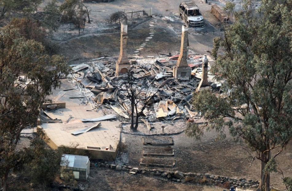 A house destroyed by a bushfire is seen in ruins in Dunalley, about 40km east of Hobart. Photo by...