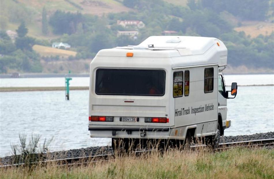 A KiwiRail inspection vehicle travels down the railway line between Port Chalmers and Dunedin.