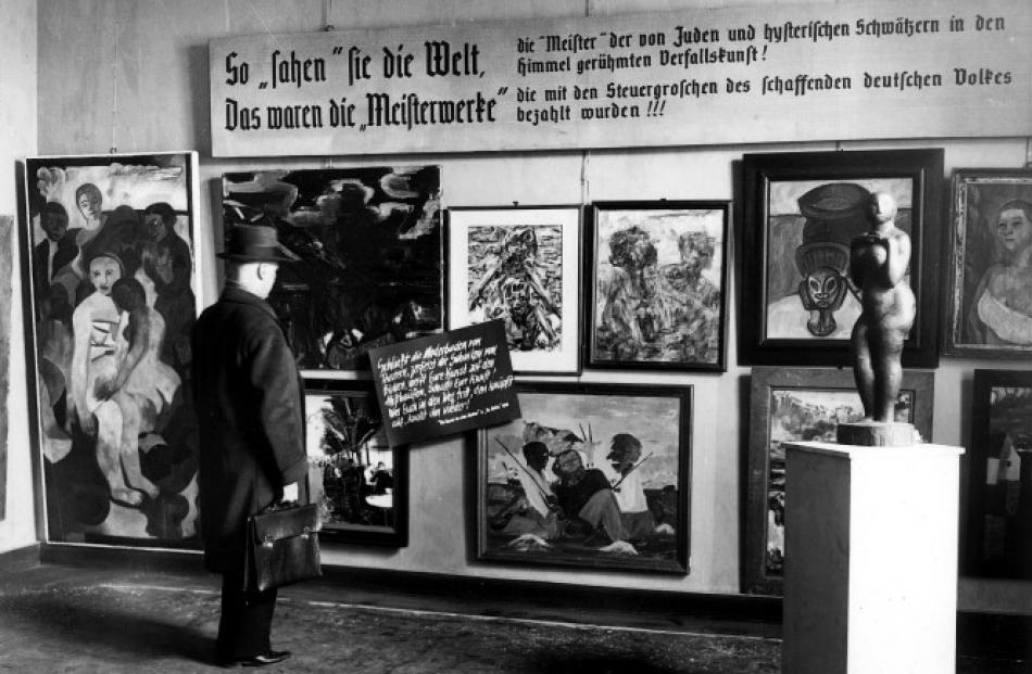 A man looks at pieces from the Nazi-curated travelling exhibition, 'Degenerate Art' (Entartete...