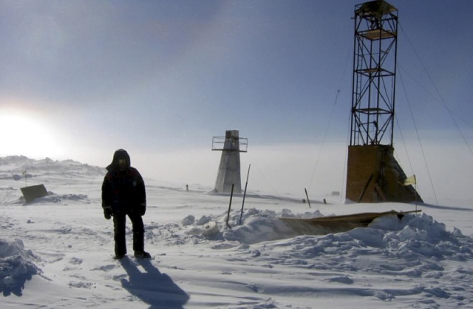A man stands near drilling apparatus at the Vostok research camp in the Antarctic in this January...