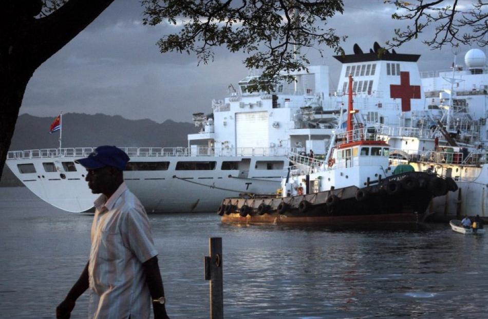 A man walks past The Peace Ark, a Chinese hospital ship which offers free health care as it sails...