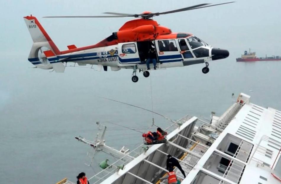 A maritime police helicopter crew rescues passengers from the capsized ferry. REUTERS/West...