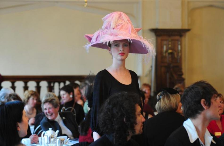 A model displaying a hat from the last 100 years at the Zonta Metropolitan Dunedin club's Hat...
