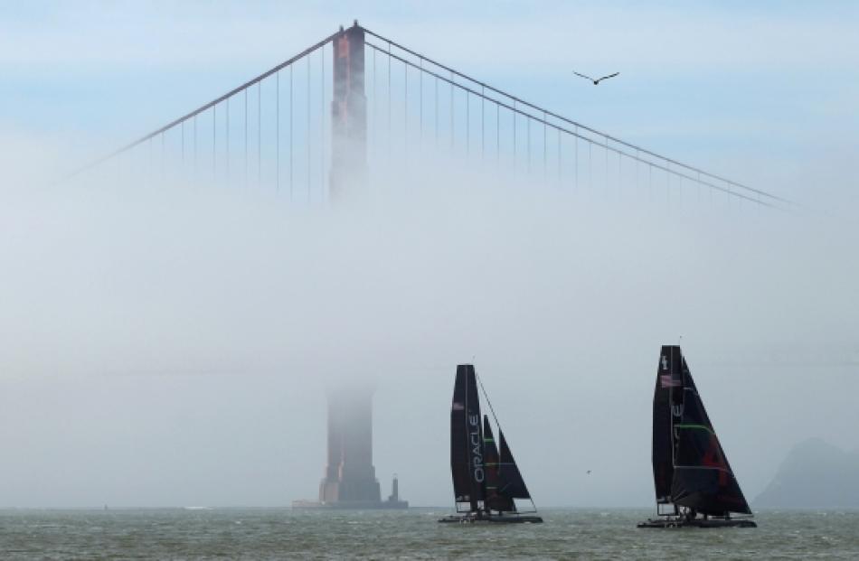 A pair of AC 45 from defending America's Cup champion Oracle Racing sails near the South Tower of...