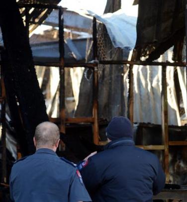 A pair of firemen inspect the damage this morning. Photos by Peter McIntosh