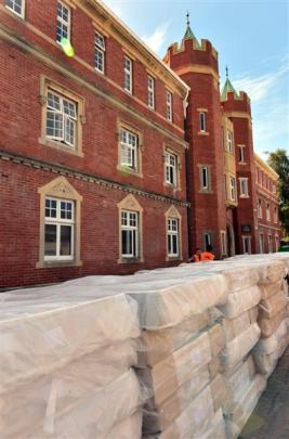 A pile of new mattresses sits outside Selwyn College, which is being refurbished and earthquake...