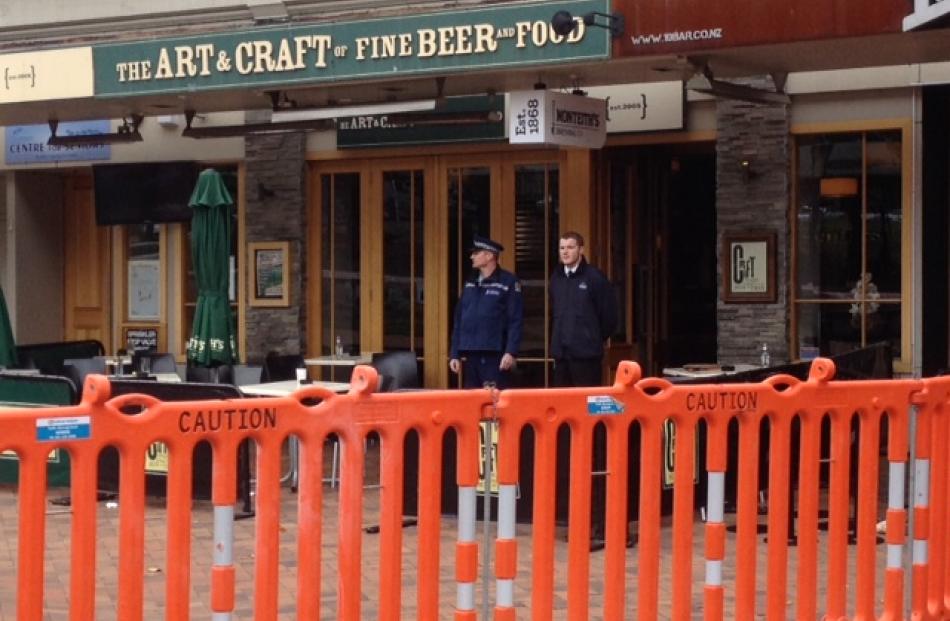 A police officer and security guard at the entrance to Craft. Photo by Hamish McNeilly