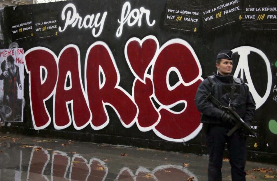 A police officer stands guard at Place de la Republique in Paris a week after the deadly attacks....