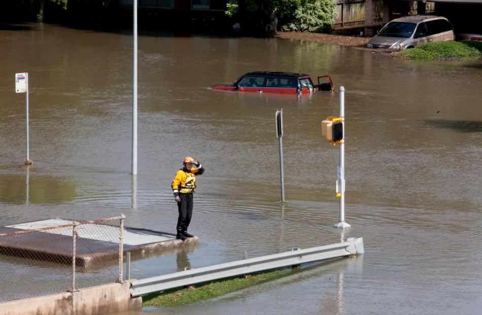 A rescue worker scans a flooded area in south Houston. Photo by Reuters