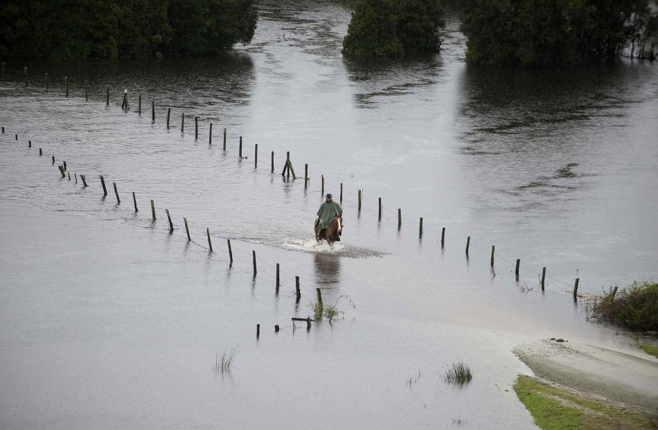 A resident rides his horse along a flooded road near Puerto Varas city, south of Santiago....