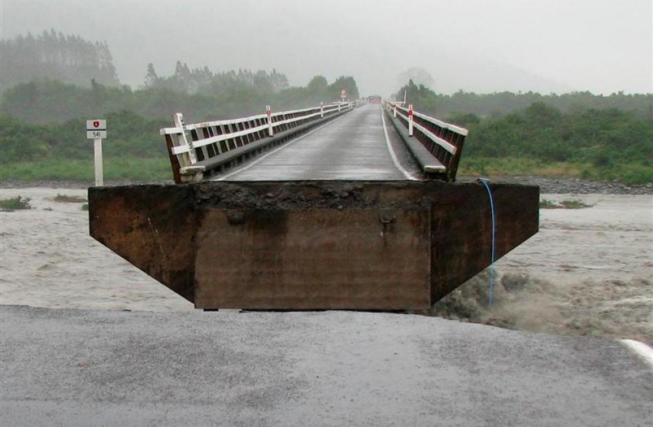 A section of the Wanganui River bridge, near Harihari, on the West Coast, was swept away by...