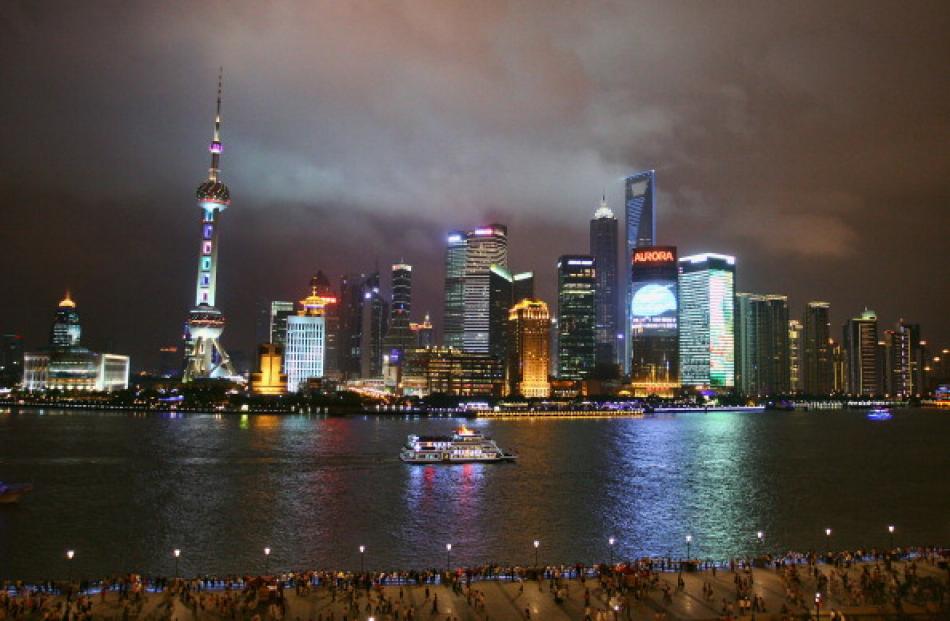 A sightseeing ship on the Huangpu River in Shanghai. China's economic growth is creating...