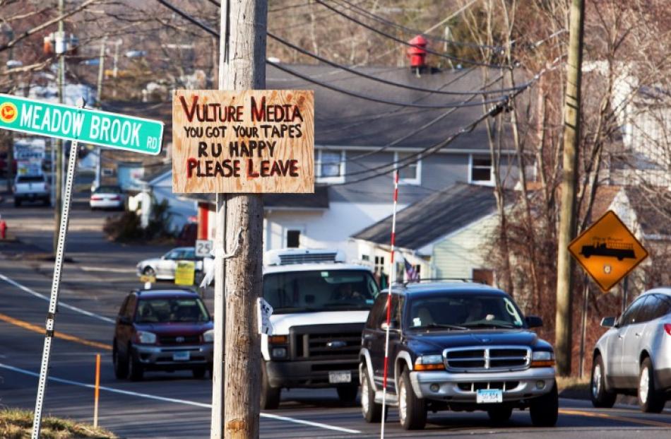 A sign expressing displeasure with the media is tacked on a pole in Newtown, Connecticut. REUTERS...
