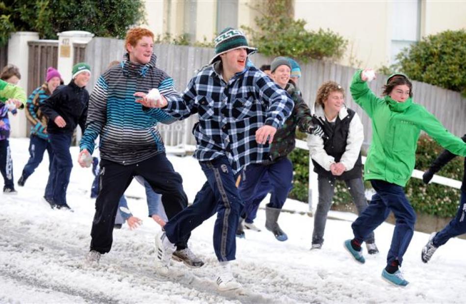 A snow attack is unleashed in Highgate, Dunedin, yesterday. Photo by Stephen Jaquiery/Craig Baxter.