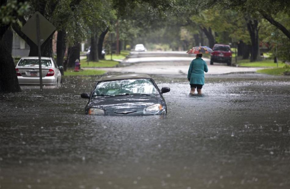 A South Carolina resident abandons her car after it stalled in flood waters. Photo: Reuters