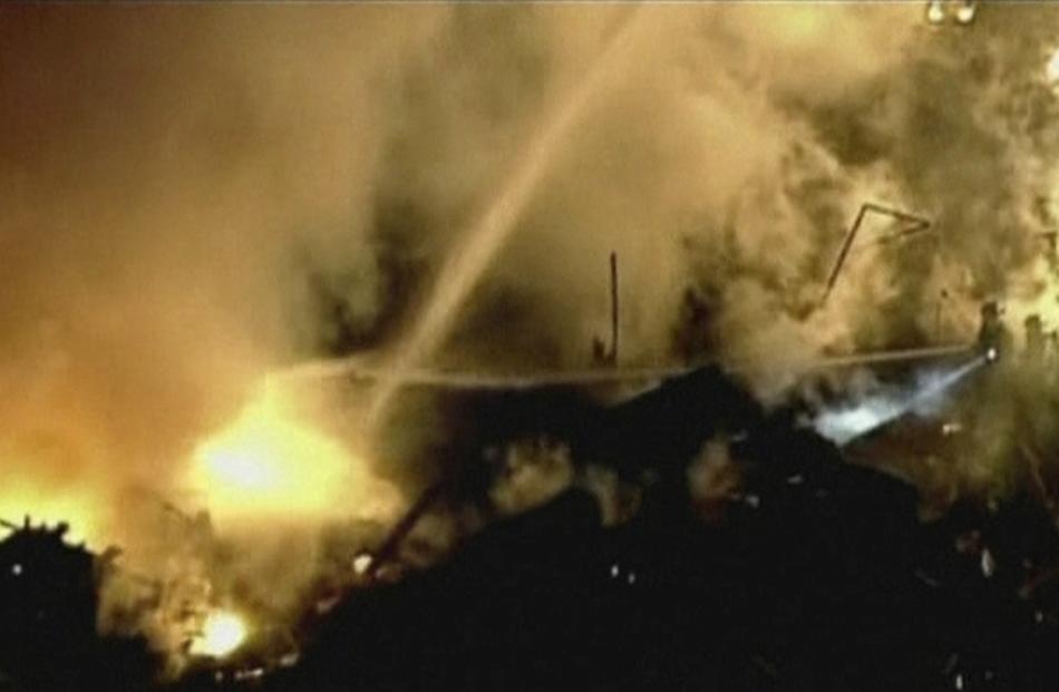 A still image taken from a KHSB-TV video footage shows aerial of the flames and firefighters...