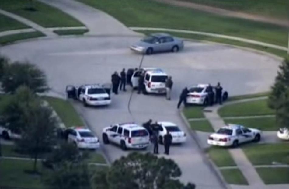 A still image taken from KPRC-TV aerial video footage shows police and a suspect in a standoff at...