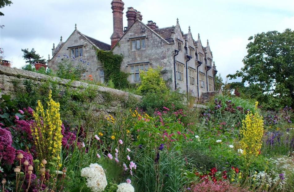 A stone wall at Gravetye Manor with a long bed of perennial flowers at its base. Photos: Gillian...