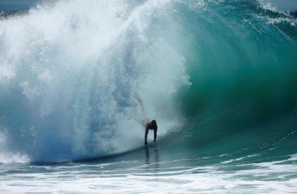 A swimmer catches a wave at 'The Wedge' wave break in Newport Beach, California. REUTERS/Lucy...
