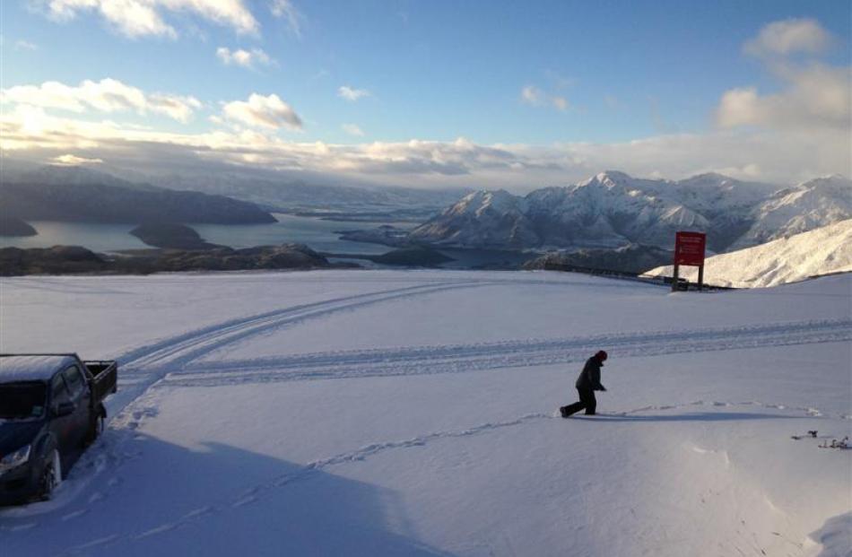 A Treble Cone employee checks the depth of new snow on the field  yesterday . Photo by Rebecca...