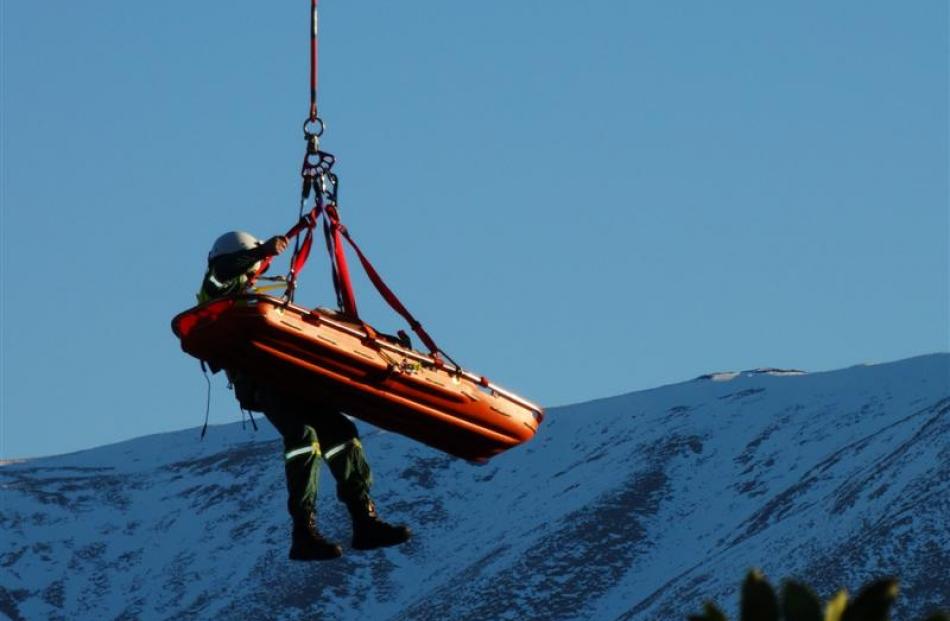 A woman is airlifted by a Lakes District Air Rescue Trust helicopter yesterday after the car in...