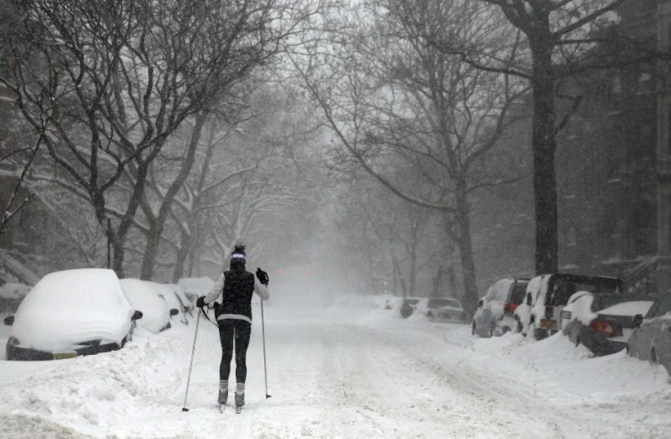 A woman skis through snow in Brooklyn, New York. Photo: Reuters