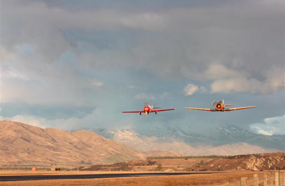 A Yak 52 (left) and Harvard T6 buzz  Wanaka airport yesterday afternoon. Photos by Leith Huffadine.