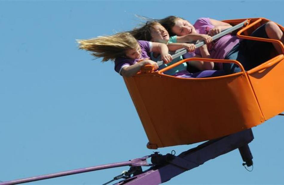 Abbey (7), Alex (5) and Amber (9) Dawson-Brown hold on during a  ride at the Otago Taieri A&P...