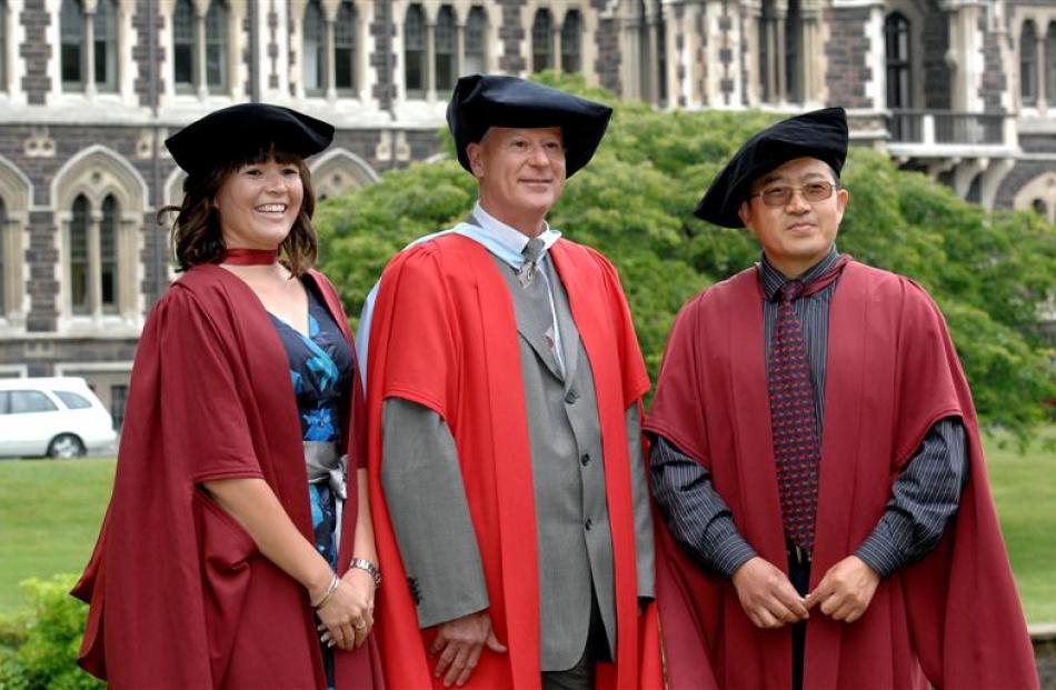 Abby Suszko, Prof John Dawson and Chinese scholar Xiju Zhao prepare to graduate from the...