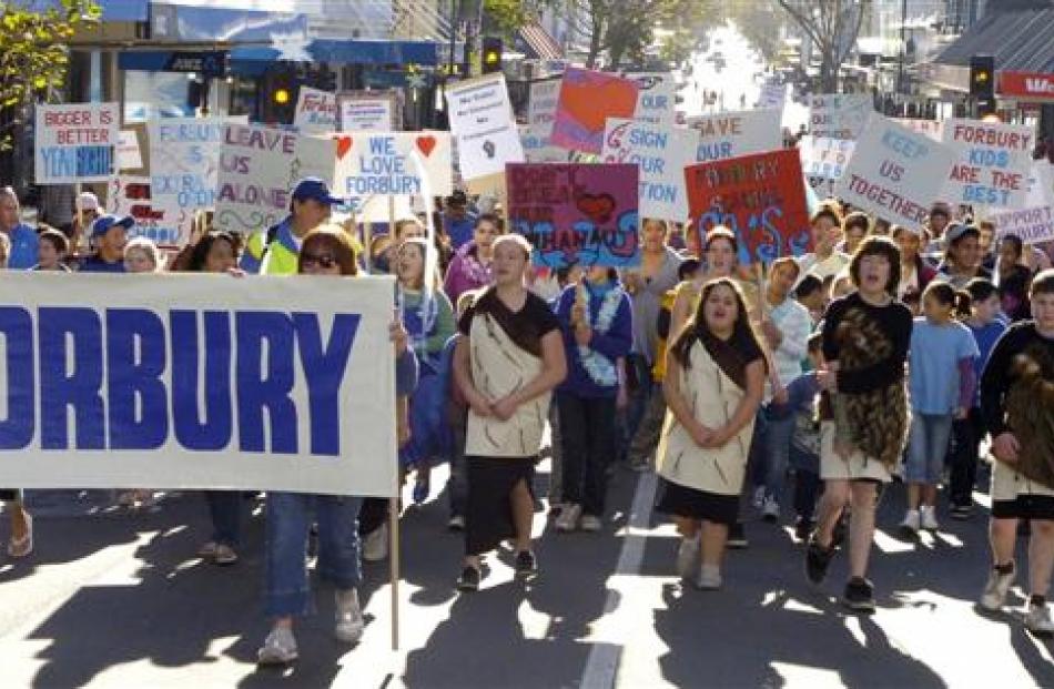 About 1000 people protest against the closure of Forbury School during a march on George St,...