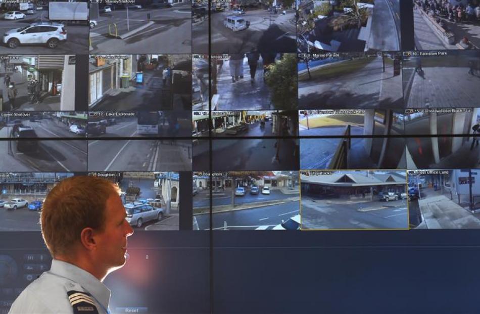 Acting Senior Sergeant James Ure, at the Dunedin Central Police Station, monitors CCTV video...