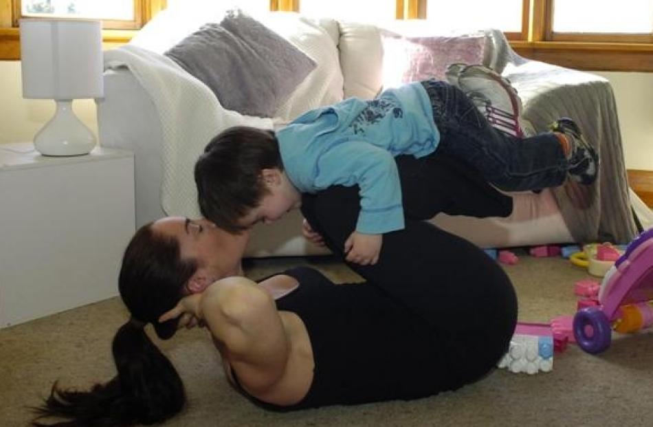 Active Mums trainer Shannon Booth demonstrates double-ended crunches (with son Coby).