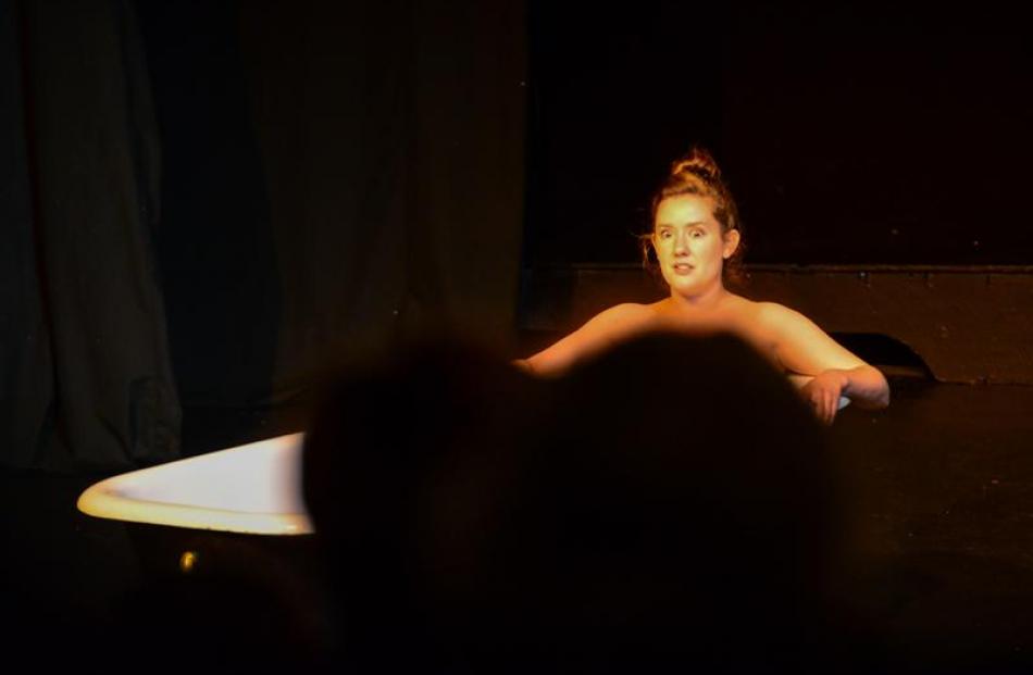 Actor Harmony Stempel performs in a tub at the Playhouse Theatre for Human Fruit Bowl on Saturday.