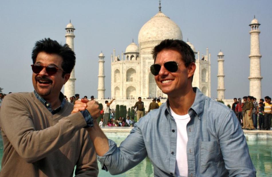 Actors Tom Cruise (R) and Anil Kapoor pose at the Taj Mahal in the northern Indian city of Agra...