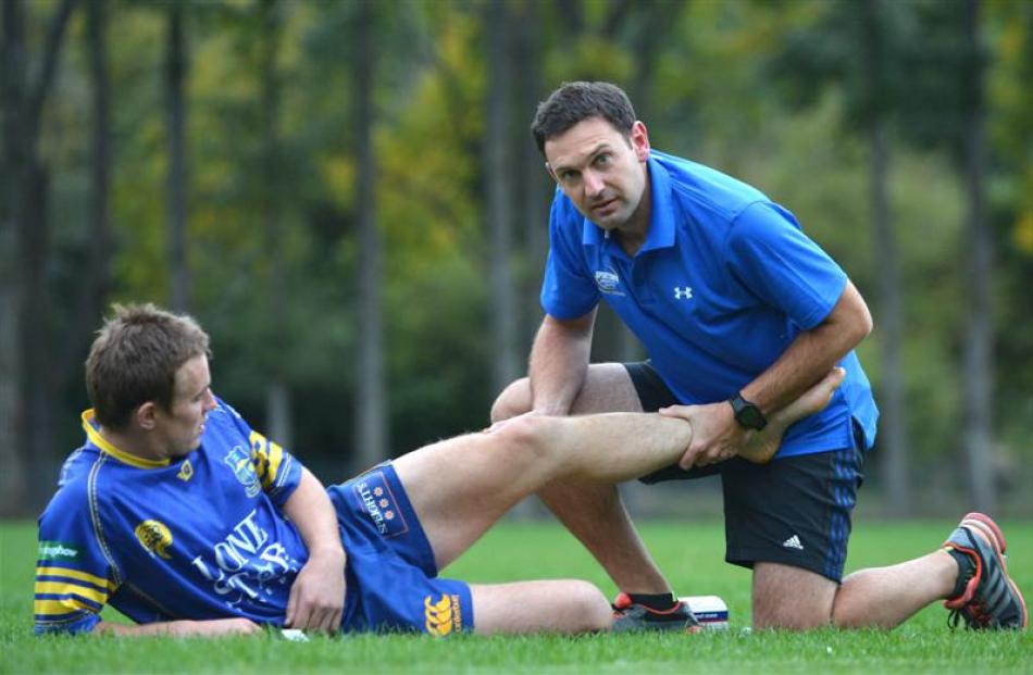 Adam Letts treats Highlanders player Hayden Parker on Monday. Photo by Peter McIntosh.