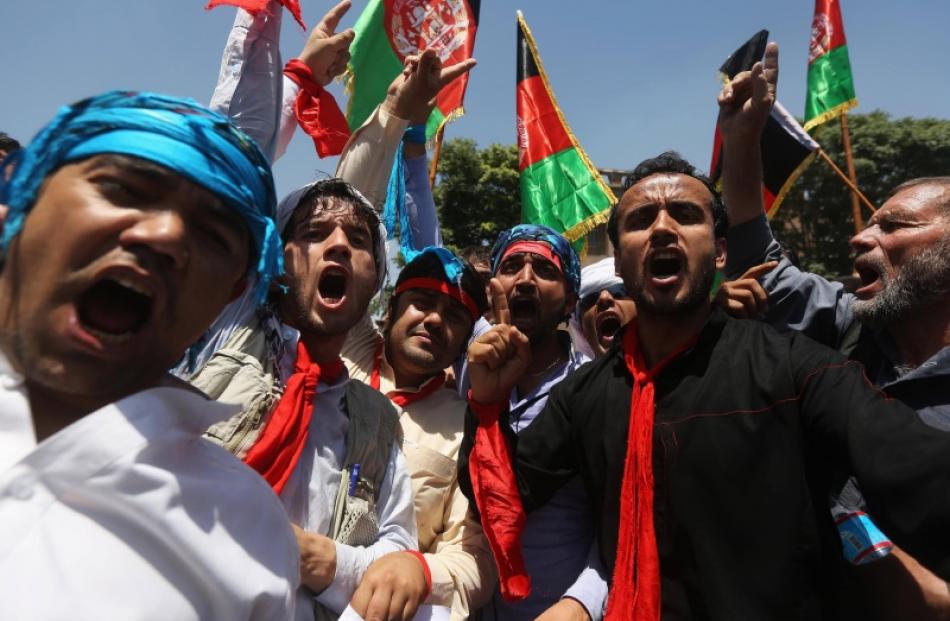 Afghans shout slogans during a protest to support presidential candidate Abdullah Abdullah, in...