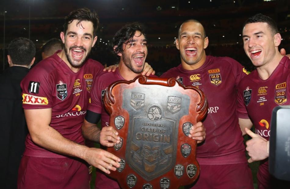 Aidan Guerra, Johnathan Thurston, Will Chambers and Darius Boyd of the Maroons celebrate victory...