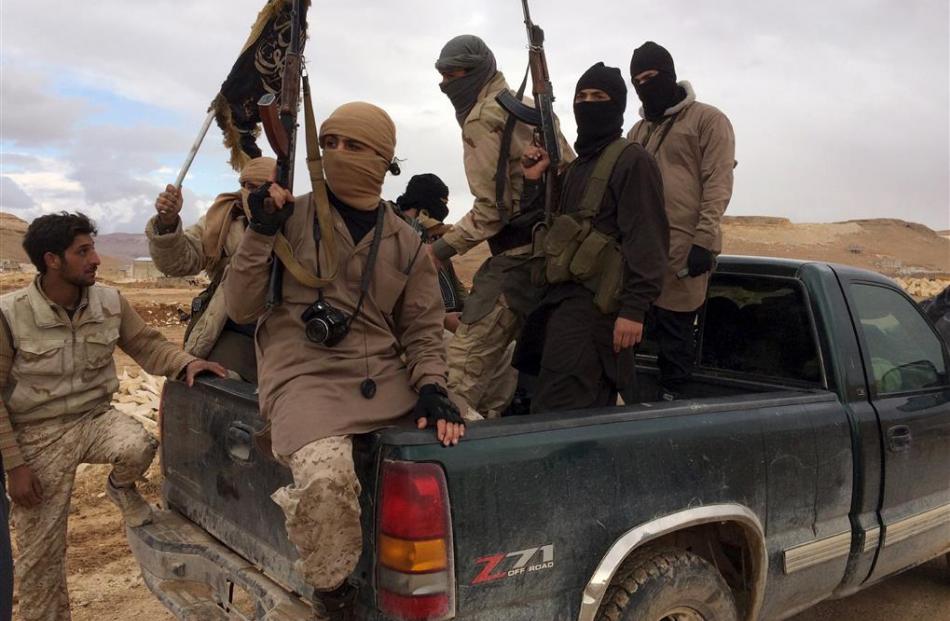 Al Qaeda-linked Nusra Front fighters during the release on December 1 of Lebanese soldiers and...