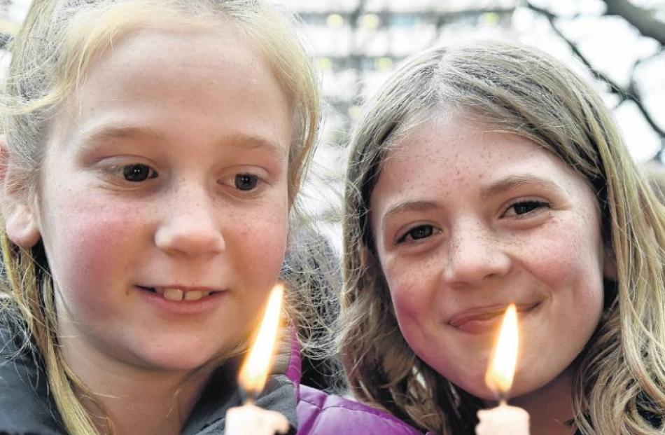 Alice Wyatt (9, left) and Juliette Romeril (10), both of Purakaunui, attend a candlelight vigil...