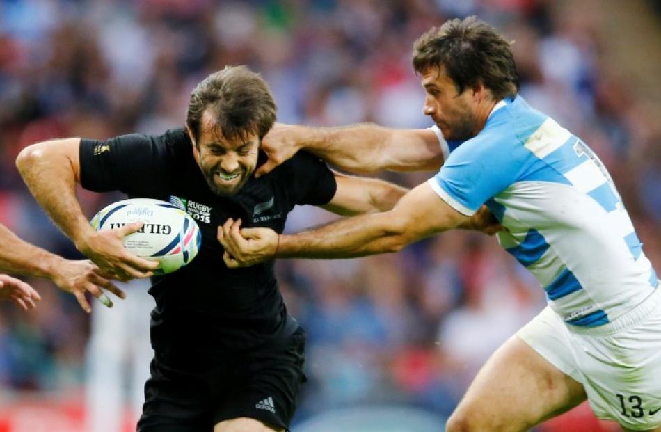 All Black centre Conrad Smith (L) tries to get past Argentina's Marcelo Bosch. Photo: Reuters