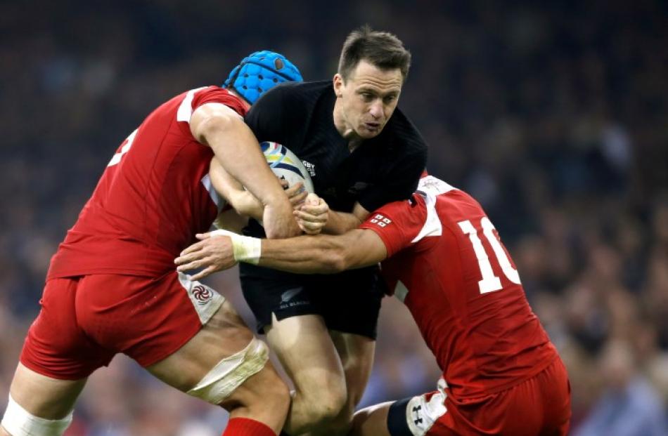 All Black fullback Ban Smith is caught by the Georgian defence. Photo Reuters