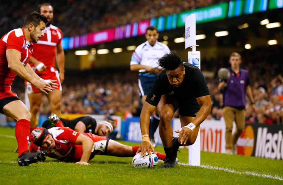 All Black left winger Julian Savea scores the first of his three tries against Georgia. Photo:...